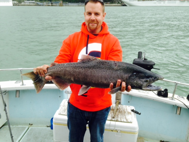 Client holding salmon catch